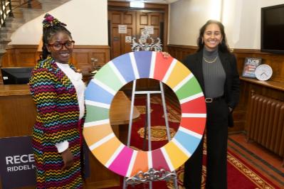 2 ladies with the UN SDG wheel